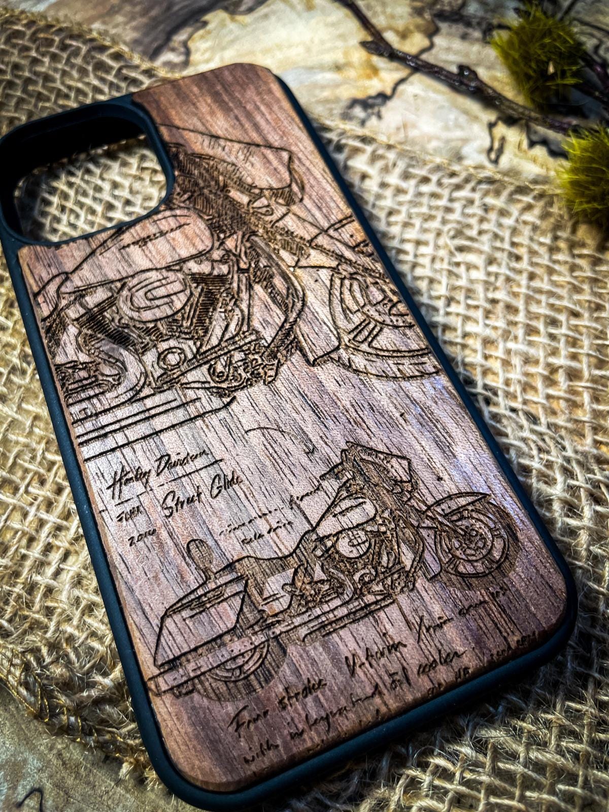 a wooden phone case with a drawing of a motorcycle