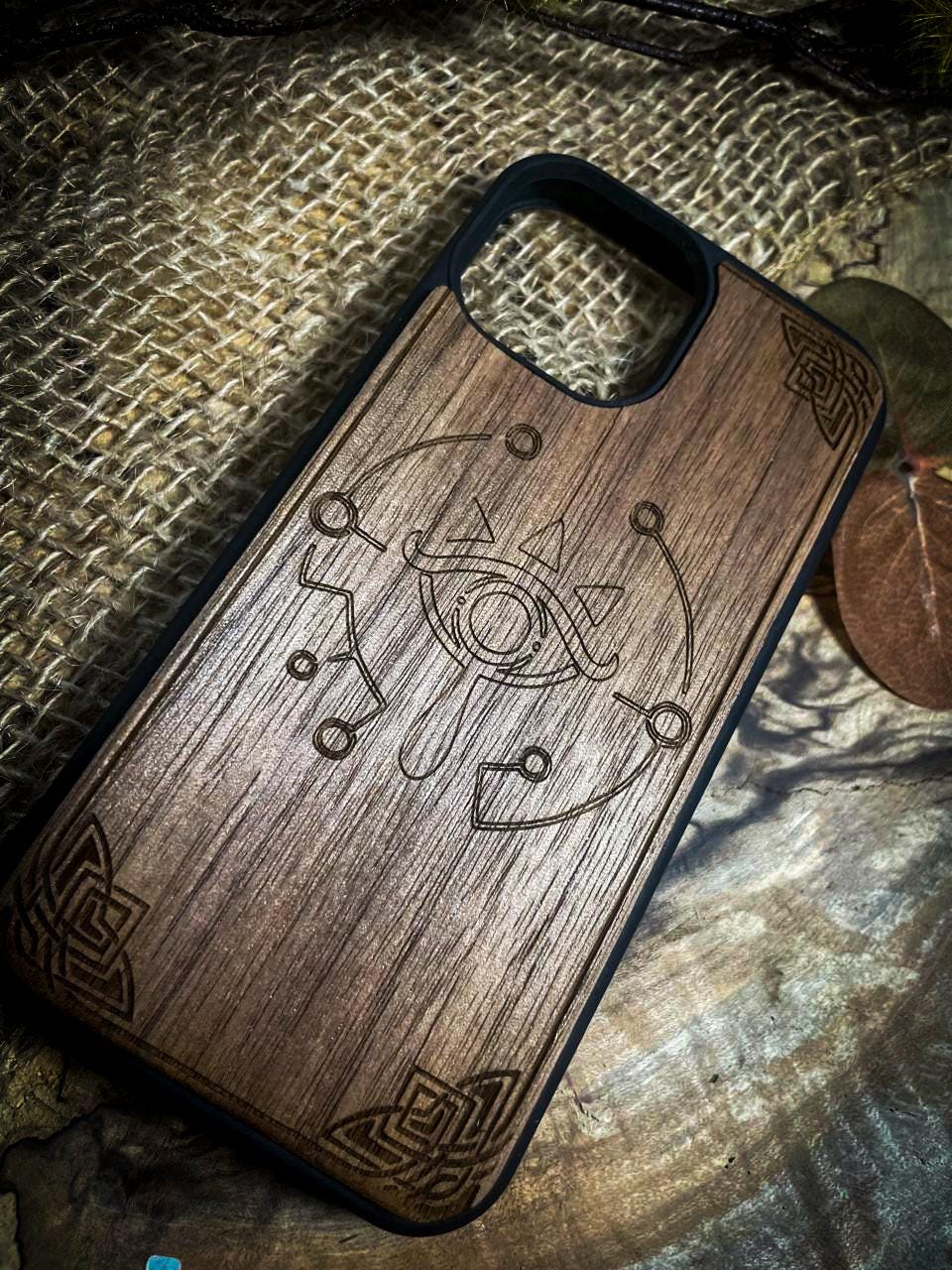 a wooden phone case with a design on it