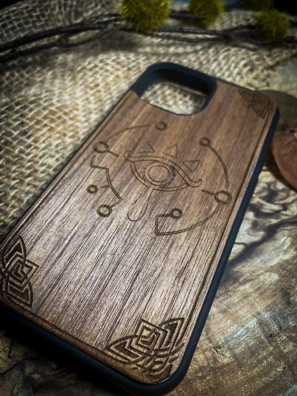 a wooden phone case with a design on it