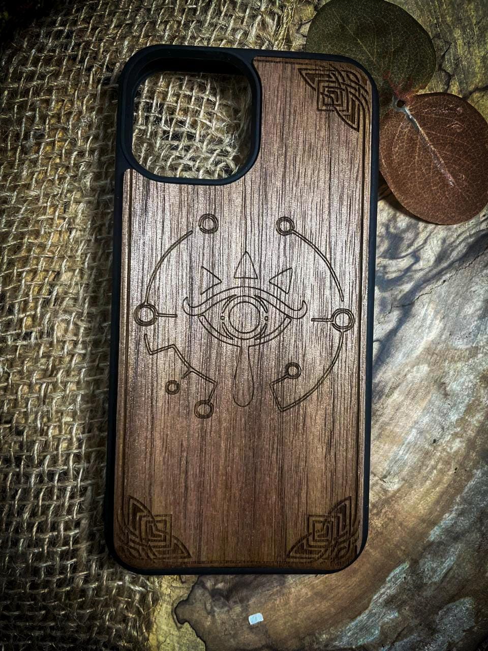 a wooden phone case with a design on it