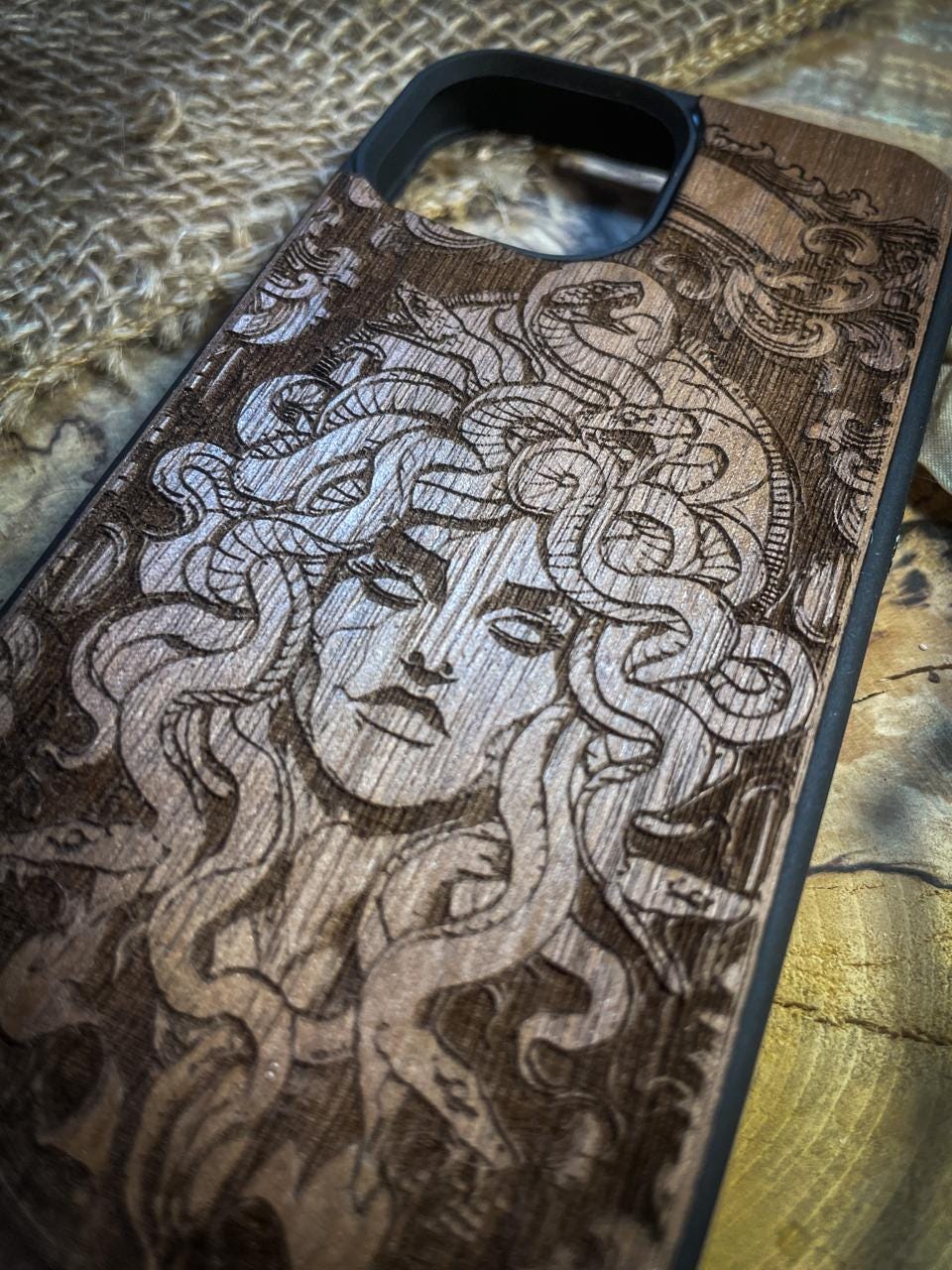 a wooden phone case with a woman's face on it